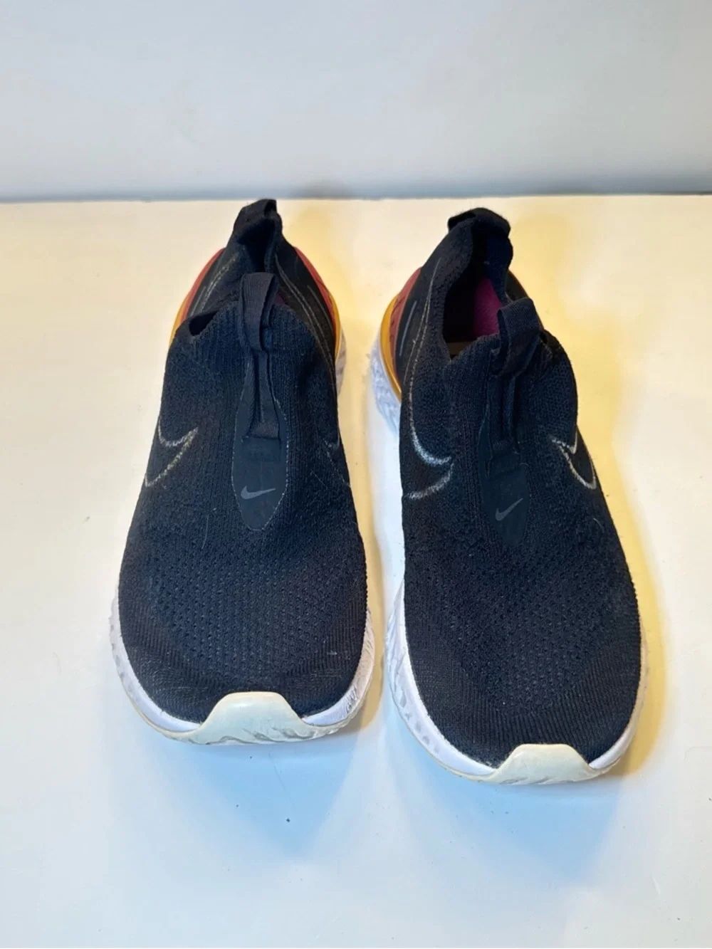 Nike Black Slip-On Athletic Shoes with Orange Heel Accent